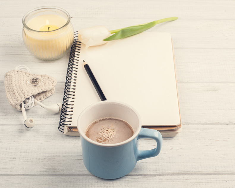 Notebook with coffee and candle for therapy and medication management with Dr. Meredith Weiss